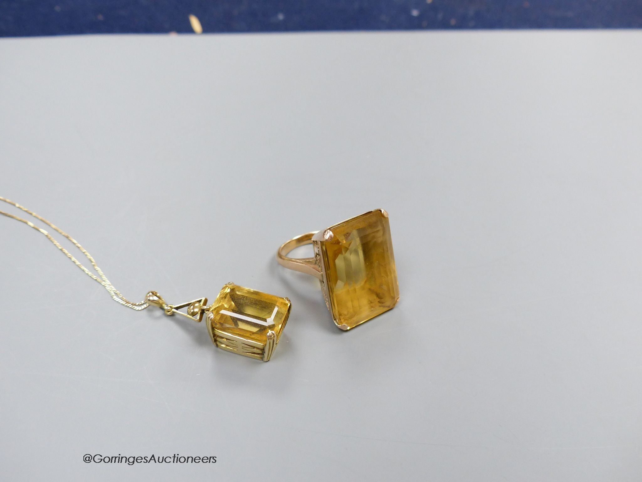 A large yellow metal mounted citrine ring, size M, gross 19.4g. and a similar pendant